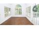 Bright dining room features hardwood floors, large windows, vaulted ceilings, and a view to the deck at 200 Ridge Bluff Ln, Suwanee, GA 30024