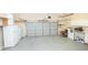 Spacious garage with work area, shelving, and large overhead door at 200 Ridge Bluff Ln, Suwanee, GA 30024