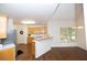 Eat-in kitchen featuring light wood cabinets, breakfast bar, stainless steel refrigerator, and wood flooring at 200 Ridge Bluff Ln, Suwanee, GA 30024