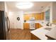 Well-lit kitchen boasts light wood cabinets and stainless steel refrigerator with wood flooring at 200 Ridge Bluff Ln, Suwanee, GA 30024