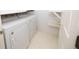 Bright laundry room with modern washer and dryer and convenient shelving at 200 Ridge Bluff Ln, Suwanee, GA 30024