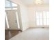 Spacious living room featuring carpet, chair rail, and natural light from the front door at 200 Ridge Bluff Ln, Suwanee, GA 30024