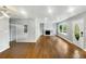 Bright living room with wood floors, fireplace, large windows, and stylish front door at 2472 Tyler Way, Decatur, GA 30032