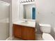 Bathroom with vanity, large mirror with lighting, glass shower doors, and a standard toilet at 453 Inkberry Dr, Atlanta, GA 30349