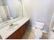 Clean bathroom featuring a single vanity, tile floors, and a shower-tub combo at 453 Inkberry Dr, Atlanta, GA 30349