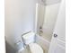 Bright bathroom featuring a tub-shower combo with white tile surround and a standard white toilet at 453 Inkberry Dr, Atlanta, GA 30349