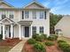 Charming townhome featuring a well-manicured lawn and inviting front entrance at 453 Inkberry Dr, Atlanta, GA 30349