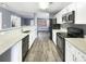 Modern kitchen featuring white cabinets, granite countertops, and stainless steel appliances at 453 Inkberry Dr, Atlanta, GA 30349