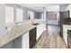 Eat-in kitchen featuring granite counters, white cabinets, and stainless steel appliances at 453 Inkberry Dr, Atlanta, GA 30349