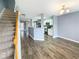 Open-concept living space with hardwood floors, staircase, and view of the kitchen at 453 Inkberry Dr, Atlanta, GA 30349