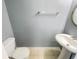 Cozy powder room features a pedestal sink, toilet, and light gray walls at 453 Inkberry Dr, Atlanta, GA 30349