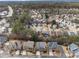 An aerial view shows the neighborhood with tree coverage and the home in relation to surrounding homes at 822 Pistace Ct, Alpharetta, GA 30022