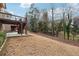 Large backyard featuring a patio, deck with stairs, and wooded area offers plenty of outdoor living space at 822 Pistace Ct, Alpharetta, GA 30022