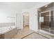 Bright bathroom features a soaking tub and separate glass-enclosed shower at 822 Pistace Ct, Alpharetta, GA 30022