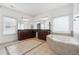 Bathroom featuring dual sinks, dark cabinets, a soaking tub, and tiled floors, creating a spa-like retreat at 822 Pistace Ct, Alpharetta, GA 30022