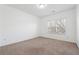 This bedroom is light and bright with neutral carpet and a large window at 822 Pistace Ct, Alpharetta, GA 30022