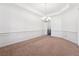 Dining room with neutral carpet, modern chandelier and bright white walls at 822 Pistace Ct, Alpharetta, GA 30022