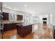 Spacious kitchen featuring an island, stainless steel appliances, and an open layout seamlessly connecting to the living area at 822 Pistace Ct, Alpharetta, GA 30022