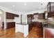 This kitchen boasts sleek dark cabinetry, modern stainless steel appliances, and ample counter space for cooking at 822 Pistace Ct, Alpharetta, GA 30022