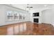 Bright living room with wood floors, gas fireplace and modern ceiling fan at 822 Pistace Ct, Alpharetta, GA 30022