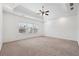 Spacious carpeted main bedroom with tray ceilings and large windows providing natural light and a serene atmosphere at 822 Pistace Ct, Alpharetta, GA 30022