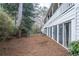 Townhome backyard featuring a row of sliding glass doors and privacy landscaping at 101 Fair Haven Se Way, Smyrna, GA 30080