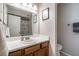 Well-lit bathroom featuring a wooden vanity, modern fixtures, and a decorative shower curtain at 101 Fair Haven Se Way, Smyrna, GA 30080
