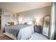 Cozy bedroom with neutral walls, bed with bedside table and lamps, decor and a full-length mirror at 101 Fair Haven Se Way, Smyrna, GA 30080