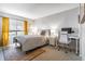 Comfortable bedroom with neutral tones, a cozy bed, a desk area, and natural light from the window at 101 Fair Haven Se Way, Smyrna, GA 30080