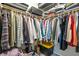 Walk-in closet fully stocked with clothes, a storage bin, and overhead compartments at 101 Fair Haven Se Way, Smyrna, GA 30080