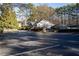 Community clubhouse surrounded by mature trees and an expansive parking lot at 101 Fair Haven Se Way, Smyrna, GA 30080