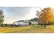 Expansive lawn and stately manor house with autumnal trees in full color at 101 Fair Haven Se Way, Smyrna, GA 30080