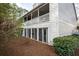 Two-story townhome features a private balcony, ground-level sliding doors, and natural landscaping at 101 Fair Haven Se Way, Smyrna, GA 30080