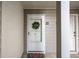 Up close exterior image of unit front door with decorative wreath and colorful welcome mat at 101 Fair Haven Se Way, Smyrna, GA 30080