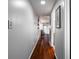 Hallway with wood floors leading to naturally-lit room and shelves at 101 Fair Haven Se Way, Smyrna, GA 30080