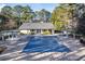 Community pool with a protective winter cover surrounded by a brick patio and mature trees at 101 Fair Haven Se Way, Smyrna, GA 30080