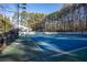 Well-maintained community tennis court surrounded by mature trees and an enclosed fence at 101 Fair Haven Se Way, Smyrna, GA 30080