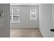 Bright bedroom with light hardwood floors and two windows with horizontal blinds at 4024 Hosch Retreat Dr, Buford, GA 30519