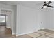 Bedroom with fan and light hardwood floors leads to adjoining room; freshly painted white walls at 4024 Hosch Retreat Dr, Buford, GA 30519