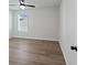 Neutral bedroom with hardwood floors, a window, and ceiling fan; great natural light throughout at 4024 Hosch Retreat Dr, Buford, GA 30519