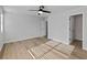 Spacious bedroom with hardwood floors, neutral walls, ceiling fan, and access to a closet at 4024 Hosch Retreat Dr, Buford, GA 30519