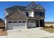Two-story home with a three-car garage, brick and siding exterior, and well-maintained landscaping at 4024 Hosch Retreat Dr, Buford, GA 30519