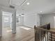 Open hallway with light hardwood floors and modern railing leads to bedrooms with ample natural light at 4024 Hosch Retreat Dr, Buford, GA 30519