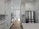 Modern kitchen featuring stainless steel appliances, white cabinets, and sleek countertops at 4024 Hosch Retreat Dr, Buford, GA 30519