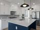 Stunning kitchen island with white countertops, blue base, stainless appliances, and pendant lighting at 4024 Hosch Retreat Dr, Buford, GA 30519
