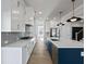 Bright and airy kitchen with white cabinets, stainless steel appliances, and a view into another room at 4024 Hosch Retreat Dr, Buford, GA 30519