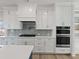 Gourmet kitchen showcasing white cabinets, stainless steel appliances, and sleek countertops at 4024 Hosch Retreat Dr, Buford, GA 30519