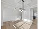 Living room featuring modern light fixtures and white wainscoting at 4024 Hosch Retreat Dr, Buford, GA 30519