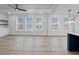 Bright living room with light wood flooring, ceiling fan, and ample natural light at 4024 Hosch Retreat Dr, Buford, GA 30519