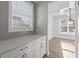 Serving area featuring quartz countertops, white cabinets, and gray backsplash at 4024 Hosch Retreat Dr, Buford, GA 30519